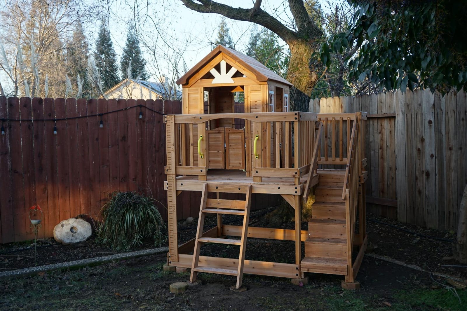 Backyard Discovery Scenic Heights Elevated Cedar Wooden Kids Playhouse with Play Kitchen, Wrap-Around Deck, Toy Storage Bench, Saloon-Style Doors, Ladder, Stairs, and Growth Chart for Outdoor Play customer photo 2